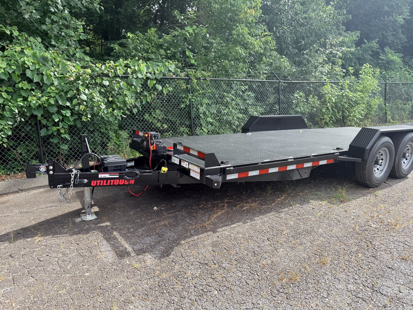 Full side view of the 2026 Hawke 20-foot power-tilt steel-deck car hauler