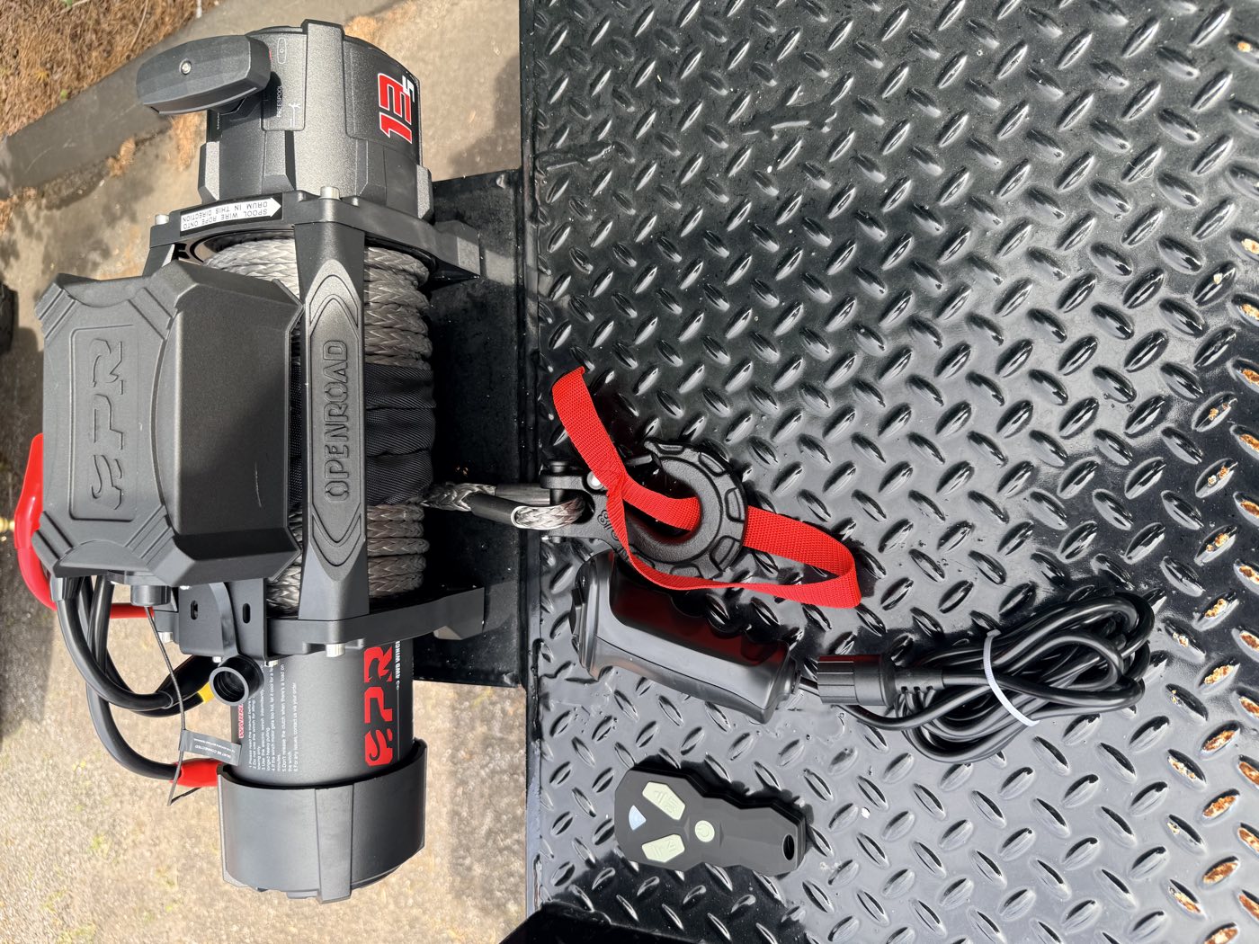 The OPENROAD 13,000 lb winch and wireless remote on the diamond-plate deck